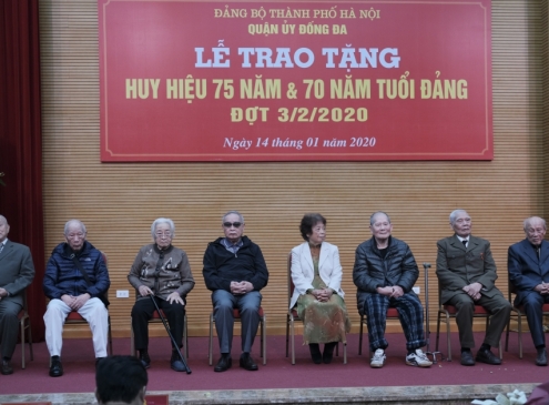 A badge awarding ceremony for people who has 75 – years and 70 – years in Party age
